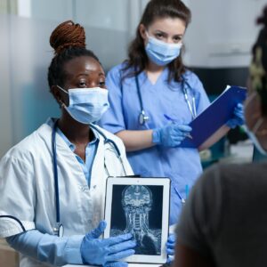 African american doctor explaining medical radiography to sick patient African american doctor explaining medical radiography to sick patient