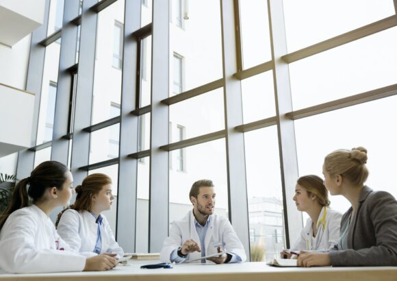 Group of doctors in meeting with consultant Group of doctors in meeting with consultant